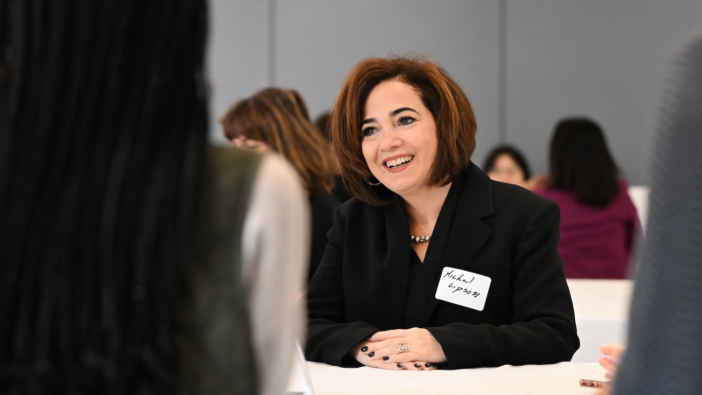Columbia Engineering professor Michal Lipson conversing with women at The “Celebrating and Networking with Columbia University's Women in STEM” event.