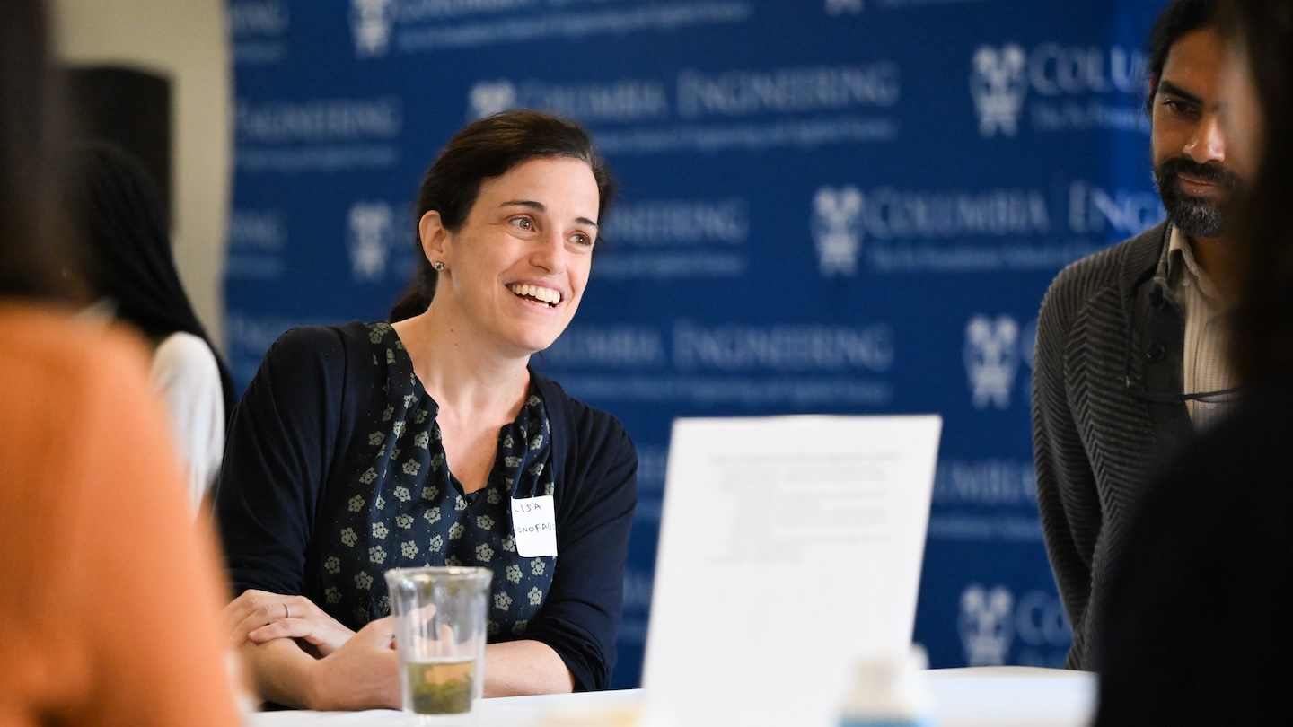 A woman smiling during conversation with others