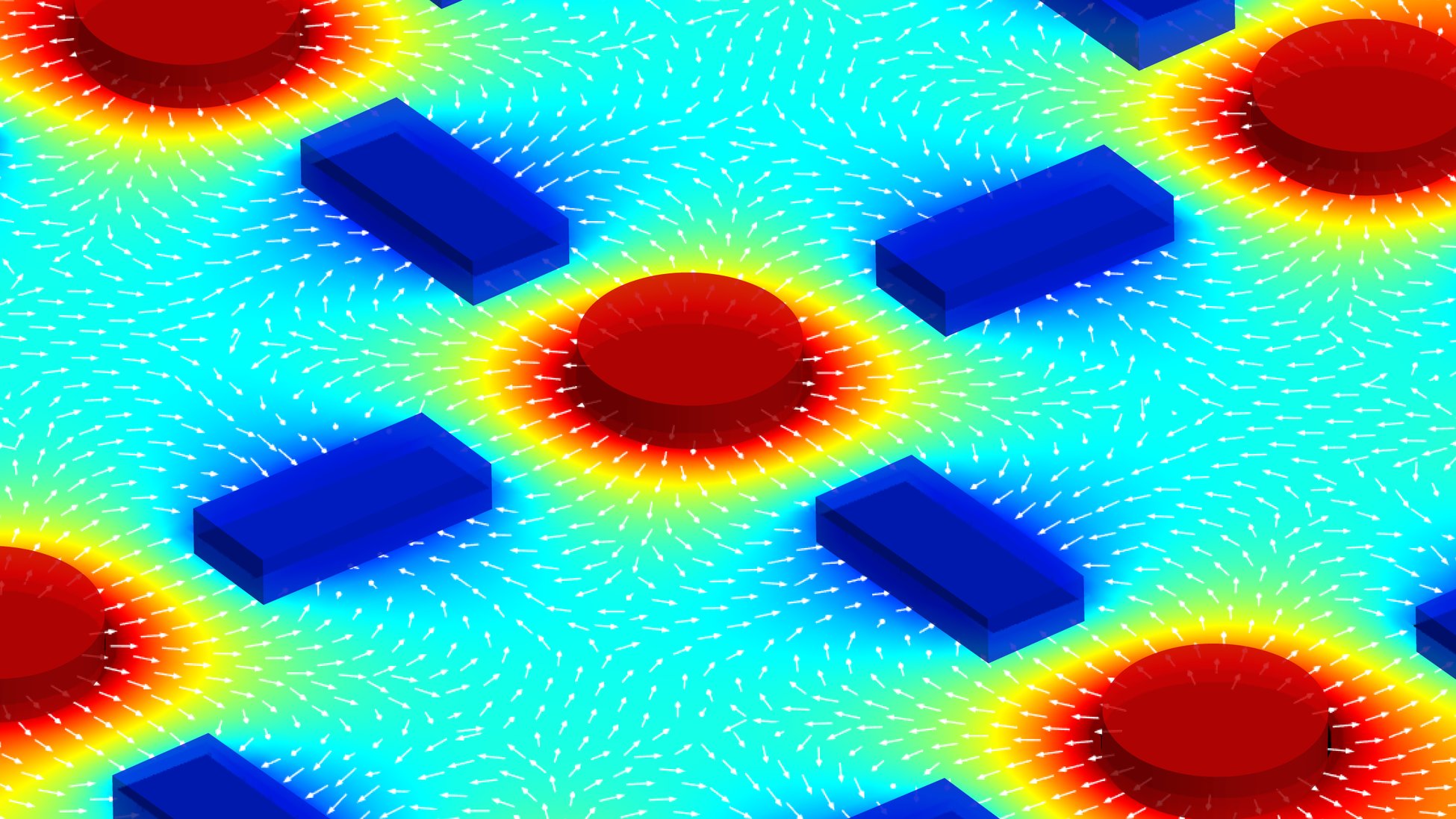 Scientific visualization featuring red circular structures and blue rectangular elements surrounded by colorful field gradients and directional vector arrows.