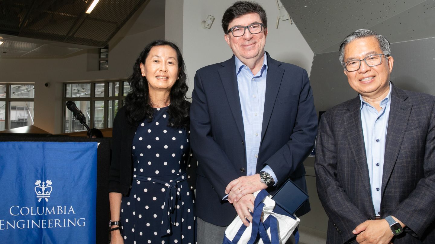Helen Lu, George Deodatis, and Dean Shih-Fu Chang pose together as Deodatis holds a Columbia Engineering tote bag.